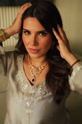 Front view of model wearing Abiha pastel stone necklace and matching earrings with traditional outfit